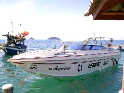the fast and the fisherman: speedboat and fishing boat taking a well deserved break together